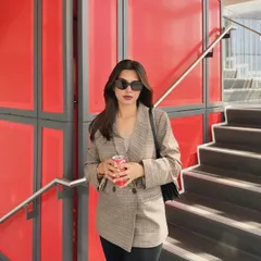 A simple joy: posing in a plaid blazer with a pop of red from a Coca-Cola can.