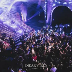 An overhead view of the packed dance floor at the Natural History Museum. This shot captures the scale of our lighting production, with beams of light creating texture and energy throughout the massive hall, drawing everyone to the party.
