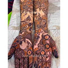 An intricate engagement henna design where I incorporated the groom's name, "Bilal," into the floral patterns on the palm. I specialize in weaving personal elements like names and dates seamlessly into the artwork.