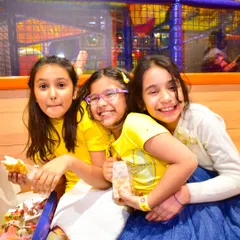 Friends sharing a laugh and a snack together. The café is a great place for kids to socialize and refuel.