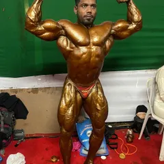 Another look at the front double bicep pose, a critical shot for judges to assess symmetry and arm development.
