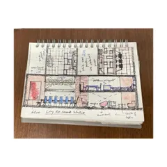 A cross-section sketch from a designer's notebook. These drawings are crucial for working out interior layouts, spatial relationships, and the human scale of a project.