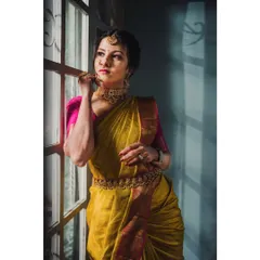 Here, the play of light and shadow from the window adds depth and emotion. This style is perfect for creating a narrative around a heritage saree collection.