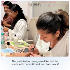 The path to becoming a professional nail technician starts with commitment and hard work. Here, a student is deeply focused on perfecting her application technique during a class.