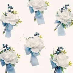 Here is a set of six matching boutonnieres ready for the groom and his groomsmen. Each spray features a single white foam rose accented with blue berries and a light blue ribbon, ensuring the whole party has a coordinated look.