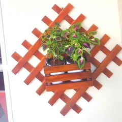 This decorative wooden lattice provides a beautiful and rustic frame for holding a potted plant. It's a simple piece that adds a lot of character to a plain wall.