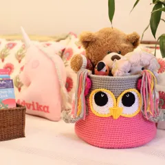 The Owlie Basket is a bestseller for a reason. It's a fun and friendly face to help keep a child's room organized, shown here holding a collection of soft toys.