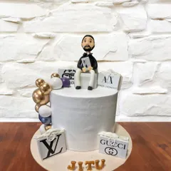 A cake for the brand-conscious, this design features logos of luxury brands like Louis Vuitton, Gucci, and Armani Exchange. A custom figurine of the birthday person sits on top.