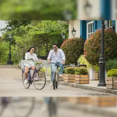A cheerful bike ride down a picturesque, European-style street. This shot captures a sense of adventure and shared fun, perfect for a dynamic pre-wedding album.