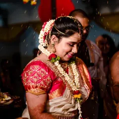 The Akshatai ceremony is a beautiful part of the wedding. Her makeup is set perfectly to remain flawless throughout the rituals, with a classic South Indian bridal hairstyle adorned with fresh jasmine and roses.