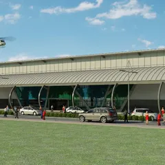 This architectural render illustrates the main terminal building of the heliport. The design features a gently curved roof and a glass facade to create a bright and open environment for passengers, with clear drop-off and pick-up zones for efficient movement.