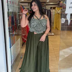 This olive green palazzo set with an attached drape is a great example of my Indo-Western designs. The heavily embroidered bustier top adds a touch of glamour, making it perfect for a mehendi or sangeet night.