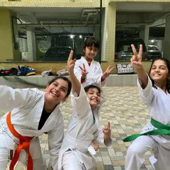 All smiles and peace signs after a great training session. We foster a positive and encouraging atmosphere where every student feels like part of the team.