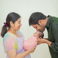 Capturing the pure love and connection in your family's first portrait is essential. In my studio, I guide families into natural, heartfelt poses that result in timeless images like this one.