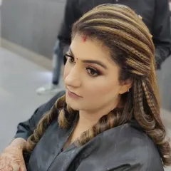 A modern and trendy hairstyle featuring a mix of crimped textures and soft curls. This look adds volume and dimension, perfect for a cocktail party or reception.
