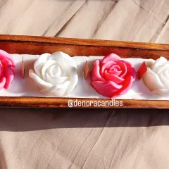 My wooden boat candles offer a rustic yet elegant charm. This piece features five beautiful rose-shaped candles, alternating in pink and white, set in a polished wooden boat tray.