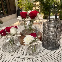 Deck the halls with this festive Christmas tablescape. I've used classic red and white roses, baby's breath, and a rustic lantern to create a cozy and joyful atmosphere for a holiday dinner.