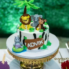 A fun jungle animal-themed cake for Advik's third birthday. Our detail shots preserve the memory of all the creative elements of your party.