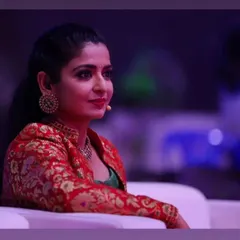 A candid shot of the talented Sushma K. Rao during a show. The makeup is designed to look polished and professional from every angle, whether on stage or sitting as part of the audience.
