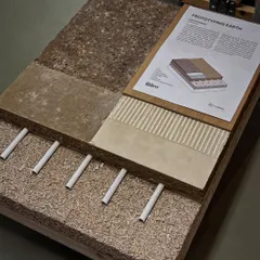 A cross-section model demonstrating the layers of an earth-based flooring system. This type of educational tool is invaluable for understanding the technical aspects of sustainable construction methods like rammed earth and earth blocks.