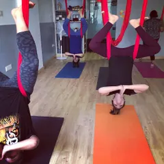 The whole group in an inverted butterfly pose during a private party session. It's a beautiful sight and a wonderful way to build trust and have fun as a group.
