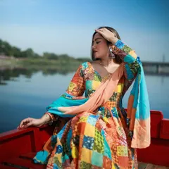 A serene, seated pose of the model on the red boat, creating a peaceful and picturesque moment.
