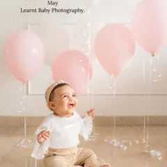 A baby's pure joy is the best thing to capture. For this milestone photo, we used simple balloons to add a touch of celebration. My goal is to create a fun and relaxed atmosphere where your little one's personality can truly shine.
