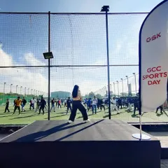 On stage leading a Zumba warm-up for GSK's Corporate Sports Day. I am experienced in setting an energetic tone for corporate events and getting employees ready for a day of activity.