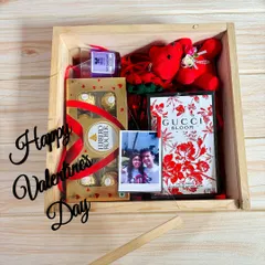 A classic Valentine's hamper in a rustic wooden box. I included a Gucci Bloom perfume, Ferrero Rochers, a teddy, a crochet rose, and a personal photo to make it extra special.