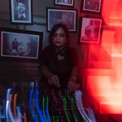 A moment of focus at Hi-Pitch Bangalore, a venue known for its dedication to underground music. The red lighting and intense atmosphere are perfect for the deep techno sets I love to play.