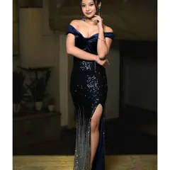 A full-length shot of a model in a stunning sequined evening gown. This type of photo is essential for a model's book to showcase how they carry themselves in formal wear.