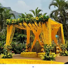 Another view of our outdoor Haldi mandap, showing how it looks in a lush green setting. We can set this up in any lawn or farmhouse across Delhi NCR, providing a complete floral decoration solution.