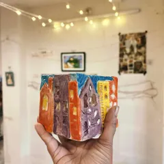 Ashna, another beginner, created this wonderfully vibrant planter that looks like a colorful city block. She wasn't afraid to experiment with bold glazes, and her playful energy shines through in this piece.