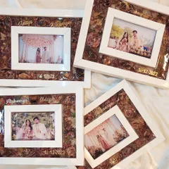 I made this set of four matching shadow box frames for a wonderful couple to give as gifts to their family. Each frame preserves their varmala flowers alongside a beautiful wedding photo, their names, and the date, all handcrafted with love.