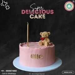 A sweet and simple cake for a first birthday. This lovely pink cake is topped with an adorable teddy bear and a single elegant candle, with "one" written in gold script.