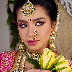 A close-up of the intricate eye makeup and classic 'Chandrakor' bindi that are hallmarks of a Maharashtrian bride. We focus on these details to create an authentic and beautiful look.