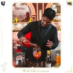 Our bartender preparing a vibrant Aperol Spritz. This shot highlights the fresh ingredients and careful technique used to create this classic, refreshing cocktail.