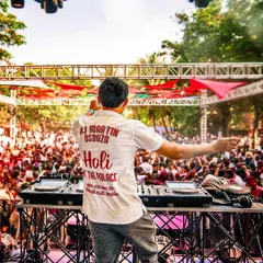 A shot from behind the decks at the 'Holi At The Palace' event, showing my custom shirt and the massive crowd in front of me.