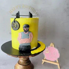 A cake for a fitness enthusiast turning 30. It features a handmade fondant caricature of the birthday boy, complete with a barbell and weight plate.