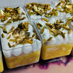These are my Kesar Pista Tres Leches Cups, made specially for Rakhi. Each cup has a moist, saffron-infused sponge soaked in rich milk and topped with pistachios and edible gold leaf.