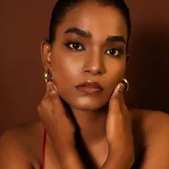 Another portrait demonstrating my skill in perfecting the base on deep skin tones. The goal is always to achieve a radiant, flawless finish that celebrates the skin's natural beauty.