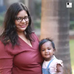 A simple, beautiful outdoor portrait of a mother and her baby. The natural light and relaxed setting help create a feeling of warmth and genuine connection.