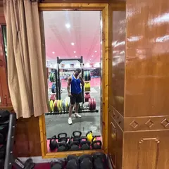 A glimpse of the well-equipped gym where I completed my certification. You can see the kettlebells and weight racks ready for action.