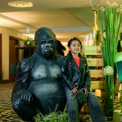 A little explorer enjoying his jungle themed party. We included life sized animal props like this gorilla to create a fun and interactive environment for the kids and a great photo opportunity.
