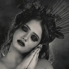 A black and white version of the creative gothic look, emphasizing the textures and dramatic shapes of the makeup and headpiece without the distraction of color.