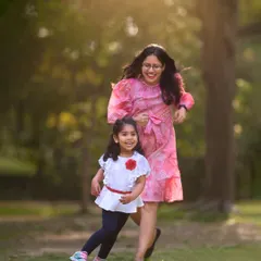 An action shot of a mother and daughter running and laughing together in a park. My sessions are full of movement to ensure the photos feel alive and authentic.