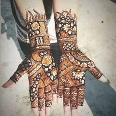 A stunning example of full-hand Indo-Arabic mehndi. The design features a mix of floral patterns, jaali work, and bold leafy vines, creating a balanced and breathtaking look for both hands.