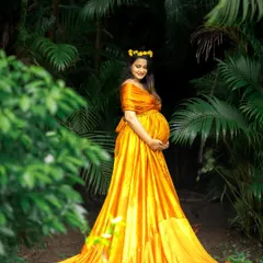 This radiant yellow gown is a client favorite, perfect for capturing the sunshine and joy of pregnancy. Its flowing fabric looks beautiful among the greenery of a park.