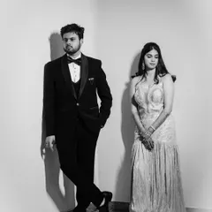 A stylish black and white portrait using strong lines and shadows to create a modern, editorial feel for this glamorous couple.