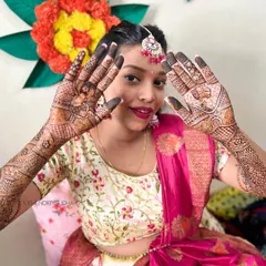 A beautiful Maharashtrian bride looking radiant and happy as she shows off her intricate wedding mehendi.